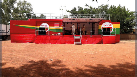 Mobile promotional truck with retractable stage and roof terrace